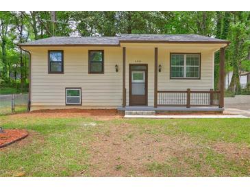 Charming home featuring a welcoming front porch, well-maintained lawn, and neutral exterior at 6454 Boca Grande Blvd, Forest Park, GA 30297