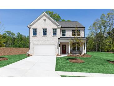 Beautiful two-story home featuring a well-manicured lawn and a white brick facade at 1771 Jordan Brook Dr, Lawrenceville, GA 30043