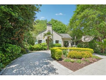 Charming home with manicured front yard, circular driveway and lush landscaping at 20 S Prado Ne, Atlanta, GA 30309