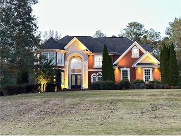Stunning brick home with manicured lawn and elegant architectural details at 20 Rosemont Pkwy, Covington, GA 30016