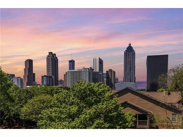 Breathtaking view of the city skyline with striking skyscrapers, set against a beautiful sunset backdrop at 405 Mcgill Park Ne Ave, Atlanta, GA 30312