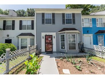 Charming townhome featuring a well-manicured front yard and traditional architectural details at 5607 Stonington Trace Pkwy, Stone Mountain, GA 30087