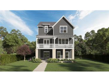 Charming two-story home with a welcoming front porch, detailed trim, and manicured lawn at 1432 Fairmont Ave, Atlanta, GA 30318