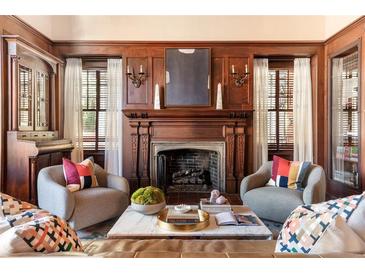 Elegant living room features a fireplace, wood paneling, and comfortable seating at 1585 S Ponce De Leon Ne Ave # 19, Atlanta, GA 30307