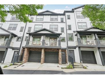 Three-story townhome showcasing attached garages and cozy balconies, providing a comfortable outdoor living space at 215 Semel Nw Dr # 455, Atlanta, GA 30309