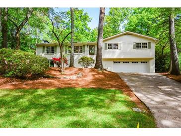 Charming split-level home with a lush front yard and a two-car garage at 2840 Wendy Ln, Marietta, GA 30062