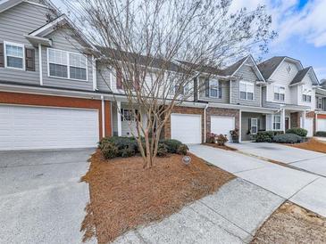 Charming townhomes boast attached garages and manicured landscaping, perfect for comfortable suburban living at 319 Franklin Ln, Acworth, GA 30102