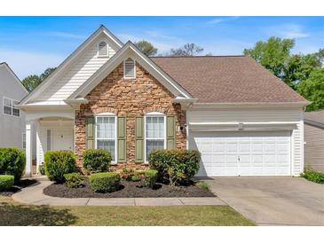Charming home featuring stone accents, manicured landscaping, and a two-car garage at 3321 Hampreston Nw Way, Kennesaw, GA 30144