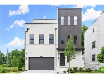 Modern exterior showcasing a two-story home with a painted brick facade, gray accents, and a two-car garage at 1420 Coretta Bnd, Atlanta, GA 30318