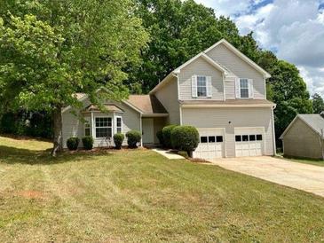 Charming two-story home with a well-maintained lawn and mature trees in a quiet neighborhood at 3432 Sumter Pl, Decatur, GA 30034