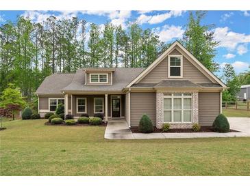 Charming single-story home with well-manicured lawn, complemented by mature trees and a welcoming entrance at 74 Stonegate Ct, Dallas, GA 30157