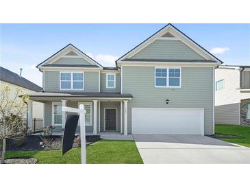 Charming two-story home featuring a two-car garage and beautifully maintained front lawn at 7161 Gladstone Cir, Lithonia, GA 30038