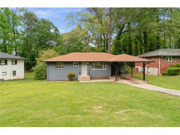 Charming single-story home with a covered carport and well-maintained front yard at 2823 Connally Sw Dr, Atlanta, GA 30311