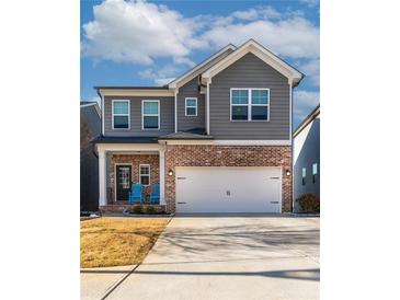 Beautiful two-story home with brick accents, gray siding, attached two-car garage, and a well-manicured lawn at 360 Winston Cir, Canton, GA 30114