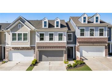 Charming townhomes with brick and siding exteriors, garages, and well-maintained lawns at 120 Maple Creek Way, Woodstock, GA 30188