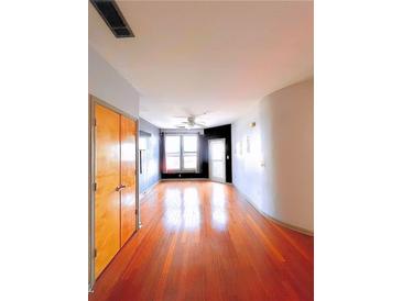 Bright living room with hardwood floors, ceiling fan, and abundant natural light at 898 Oak Sw St # 1418, Atlanta, GA 30310