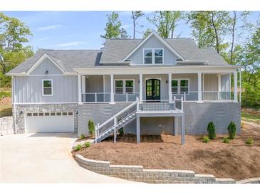 Charming two-story home featuring a welcoming front porch, gray siding, and an attached two car garage at 2841 Bettis Ct, Marietta, GA 30066