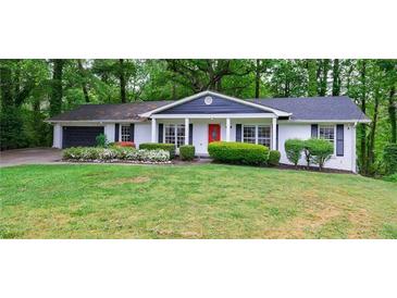 Charming single-story home with a lush green lawn and inviting curb appeal at 3803 Butternut Dr, Decatur, GA 30034