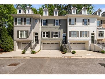 Charming townhomes with brick exteriors, dormer windows, and attached garages offer both style and convenience at 404 Wade Creek Rd, Alpharetta, GA 30009