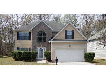 Charming two-story home with a well-manicured lawn, attached two-car garage, and classic architectural details at 2210 Benidorm Ct, South Fulton, GA 30349