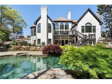 A stunning backyard pool area with lush landscaping and multi-level patio area at 1015 Bedford Gardens Dr, Alpharetta, GA 30022