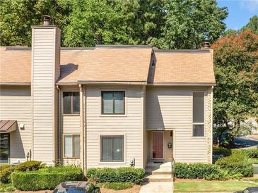 Charming two-story townhouse featuring a well-maintained lawn and a welcoming front entrance at 3500 Stonewall Pl, Atlanta, GA 30339