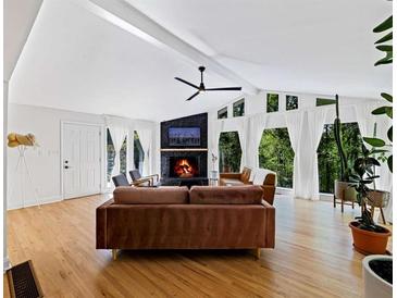 Bright living room with vaulted ceilings, fireplace, and hardwood floors at 579 Fielding Ln, Atlanta, GA 30311