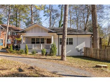 Charming bungalow with a covered front porch and a beautifully landscaped yard at 1598 Olympian Sw Cir, Atlanta, GA 30310