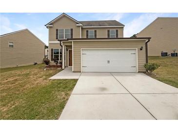 Charming two-story home with a two car garage, well-maintained lawn, and welcoming curb appeal at 4452 Belcamp Rd, Fairburn, GA 30213