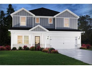 Charming two-story home featuring a manicured lawn and a two-car garage, blending classic design with modern living at 173 Soseby Lake Ln, Grayson, GA 30017