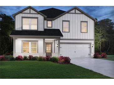 Charming two-story home features a two-car garage, landscaped yard and classic curb appeal at 376 Tallulah Ln, Grayson, GA 30017