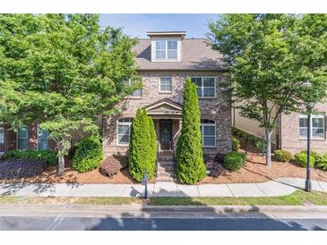 Charming brick home with well-maintained landscaping and mature trees in a desirable neighborhood at 486 Raven Brook Ln, Suwanee, GA 30024