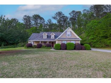 Charming single-Gathering home with manicured lawn and mature landscaping, perfect for outdoor enjoyment at 152 Cooper Creek Dr, Dallas, GA 30157