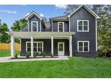 Charming two-story home with a modern gray exterior, white trim, and a welcoming front porch at 1347 Midlawn Dr, Decatur, GA 30032