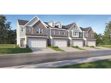 Stylish townhome exteriors with brick and siding, attached garages, and manicured lawns at 2429 Livi Ln, Buford, GA 30519