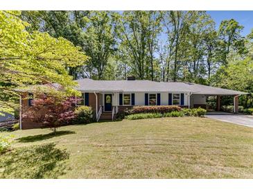Charming single-story home with brick accents, covered parking, and mature trees at 2357 Burnt Creek Rd, Decatur, GA 30033