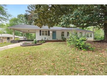 Charming single-story home featuring a covered carport, light blue door, and well-maintained front lawn at 808 Casplan Sw St, Atlanta, GA 30310