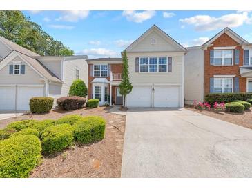 Charming two-story townhome with a manicured front yard and an attached two-car garage at 1703 Bentridge Nw Dr, Kennesaw, GA 30144