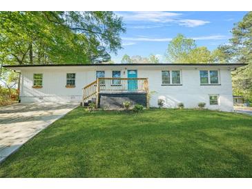 Charming single-story home with a well-maintained lawn and inviting blue front door at 2529 Ryne St, Atlanta, GA 30318
