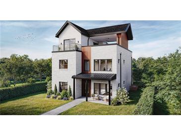 Striking three-story home featuring a modern design, balcony, and a well-manicured lawn at 324 Treble Way, Alpharetta, GA 30009