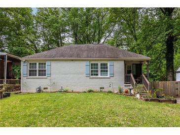 Charming one-story home with a well-maintained lawn and light blue shutters at 1866 Tiger Flowers Nw Dr, Atlanta, GA 30314