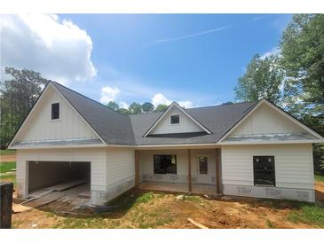 Charming new construction home featuring a two-car garage and bright, white exterior siding at 877 Highway 101 N, Dallas, GA 30157
