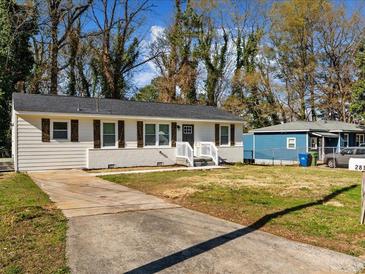 Charming single-story home with gray siding, white trim, and a well-maintained front yard at 2811 Mango Nw Cir, Atlanta, GA 30318