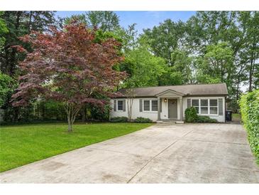 Charming single-story home with a well-manicured lawn and a concrete driveway at 2171 Plantation Ln, Chamblee, GA 30341