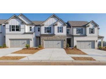 Charming townhomes with stone accents, a garage, and manicured front yards create a welcoming curb appeal at 4948 Jatoba Rd, Acworth, GA 30101