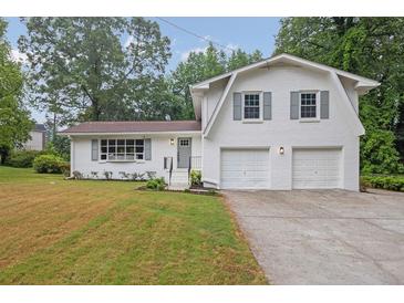 Charming two-story home with a two-car garage and nicely manicured front yard at 3182 Wakefield Dr, Decatur, GA 30034