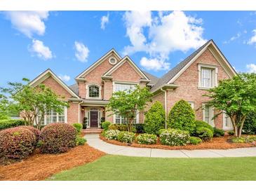 Stunning two-story brick home with manicured landscaping and inviting curb appeal at 1364 Gulfport Run, Grayson, GA 30017