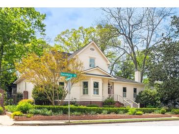 Charming two-story home with landscaped yard featuring manicured hedges and lush green trees on a beautiful lot at 511 Sycamore St, Decatur, GA 30030