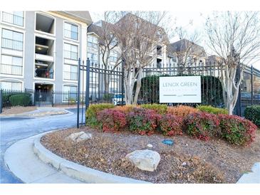 Exterior view of Lenox Green Condominium entrance sign with colorful landscaping and a black wrought iron fence at 2657 Lenox Ne Rd # 68 Bld, Atlanta, GA 30324