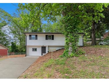 Charming two-story home with a freshly painted white exterior and driveway at 3181 Pennington Sw Cir, Atlanta, GA 30354
